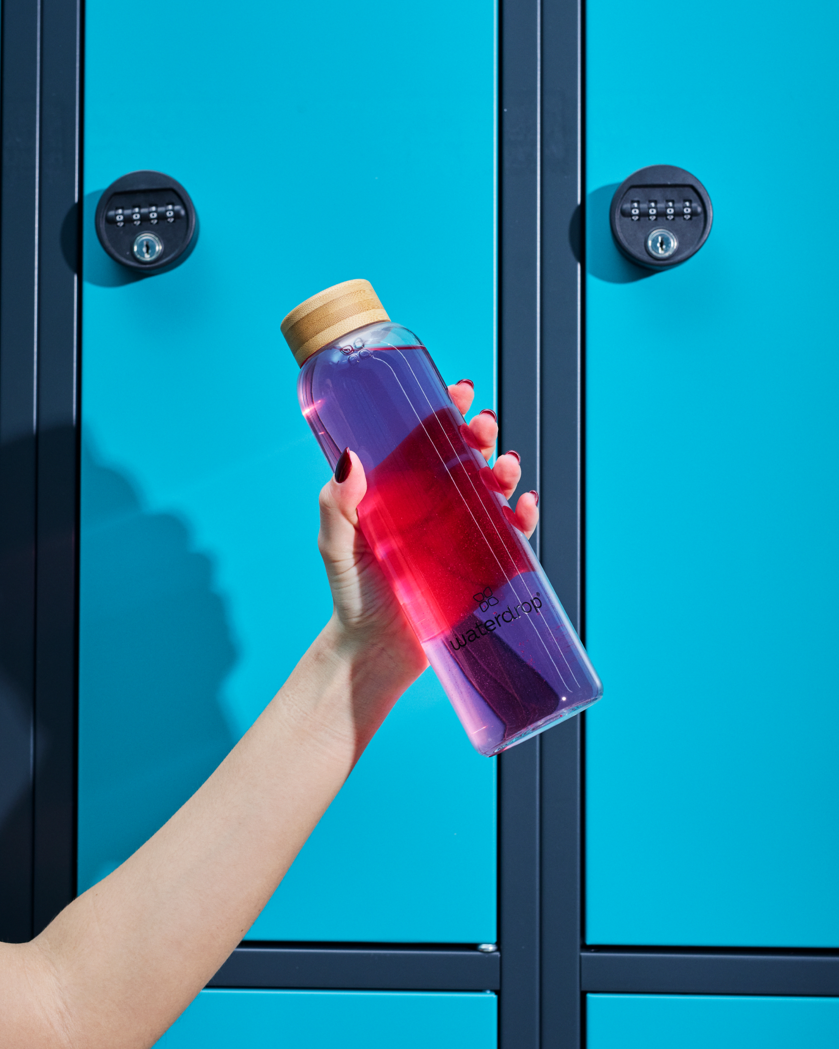 Hand holding a Microlyte Set bottle of electrolyte-rich drink, featuring flavors like BERRY, BLUEBERRY, GRAPEFRUIT microdrink, and MELON.