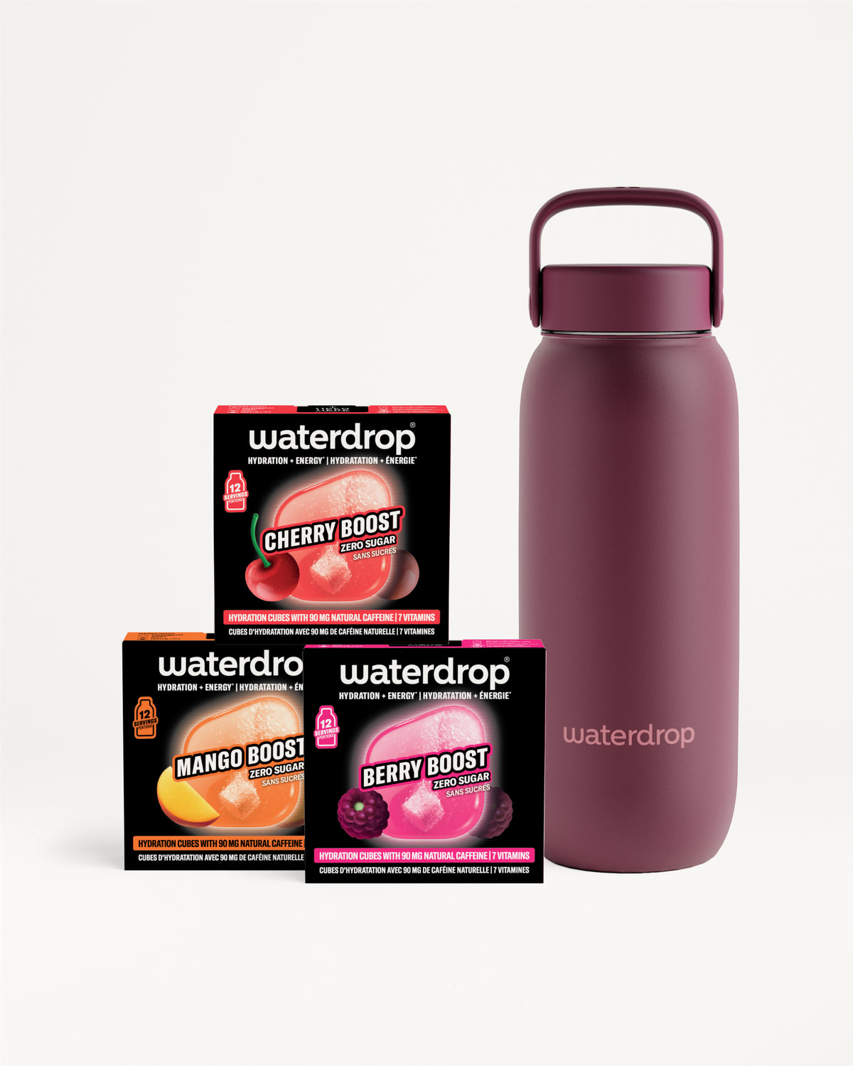 Magenta insulated water bottle with a handle beside three small black boxes.