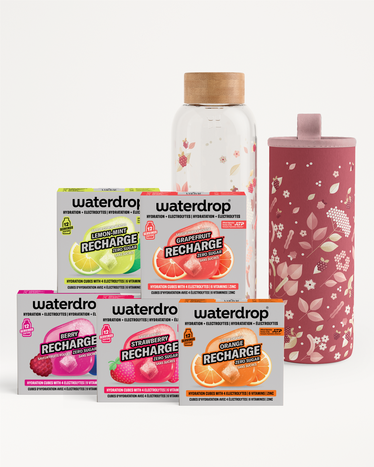 Assorted Waterdrop Recharge flavor sachets with a glass bottle and a pink floral tumbler.
