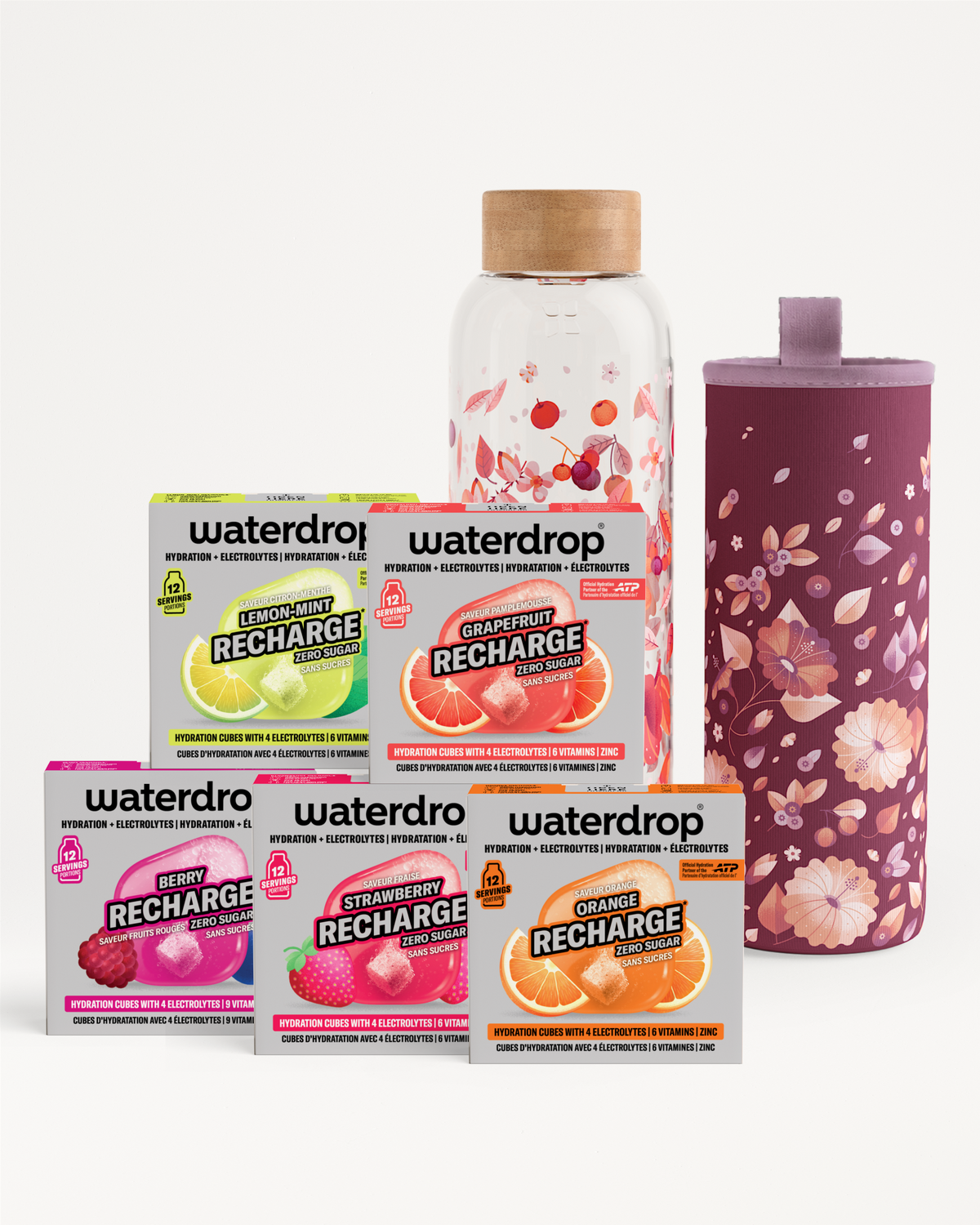Assorted flavor recharge packets with a clear bottle and a purple floral tumbler beside them.