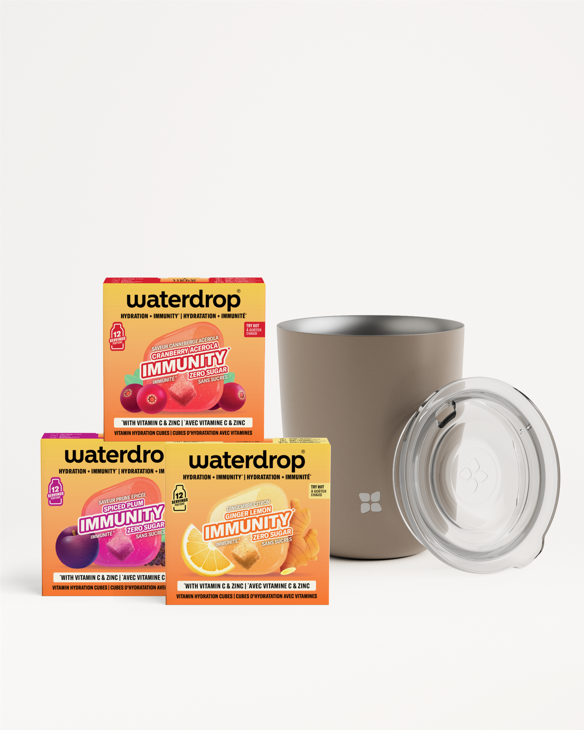 Set of three colorful drink-mix boxes and a stainless steel tumbler with a clear lid.