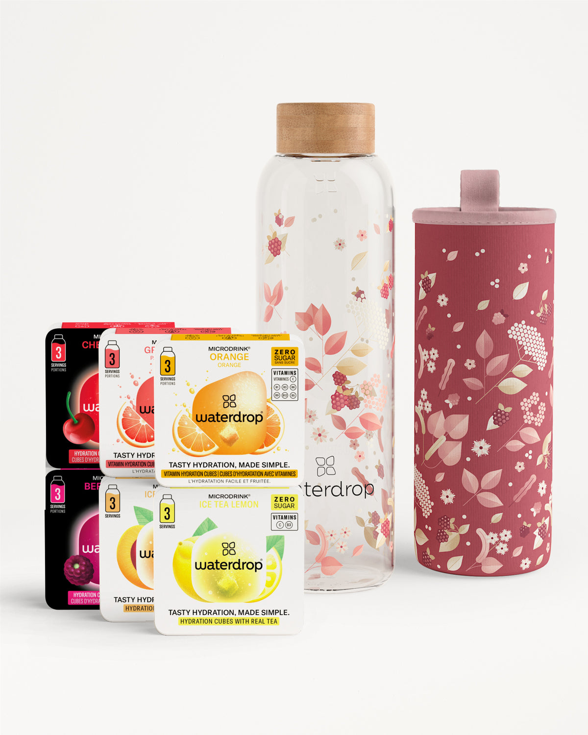 Assorted Waterdrop beverage mix sachets with a glass bottle featuring a wooden cap and a pink floral insulated bottle sleeve.