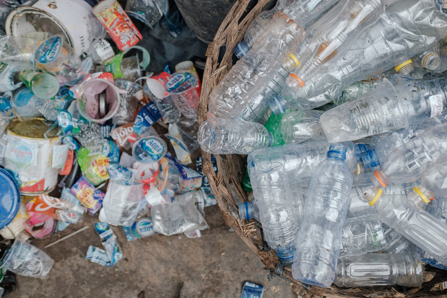 A basket filled with assorted plastic bottles, highlighting environmental litter and emphasizing the importance of sustainable hydration solutions.