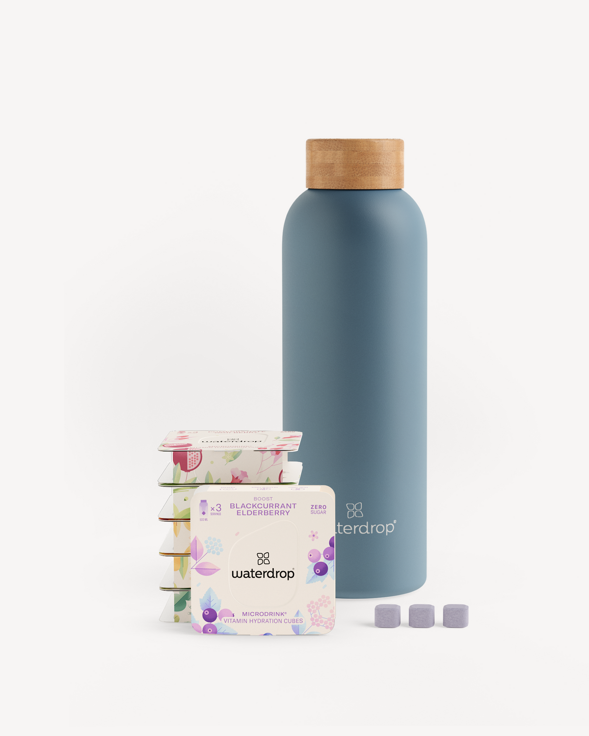 Starter Set Microdrink Thermo Steel featuring a stainless steel bottle and six 3-packs of Microdrink flavors, displayed with packaging.