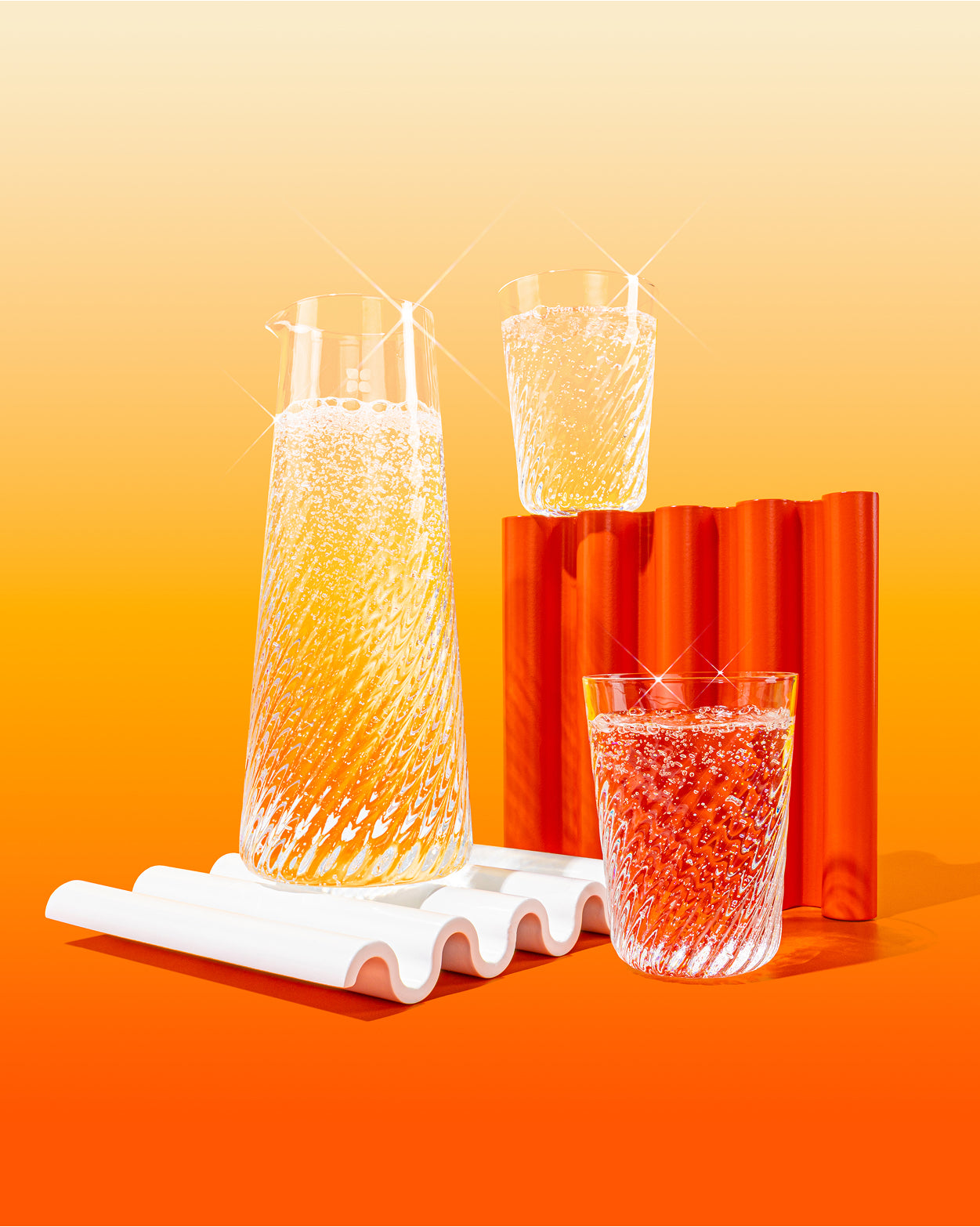 Rippled Glasses set, featuring elegant swirl design, with fizzy drinks.
