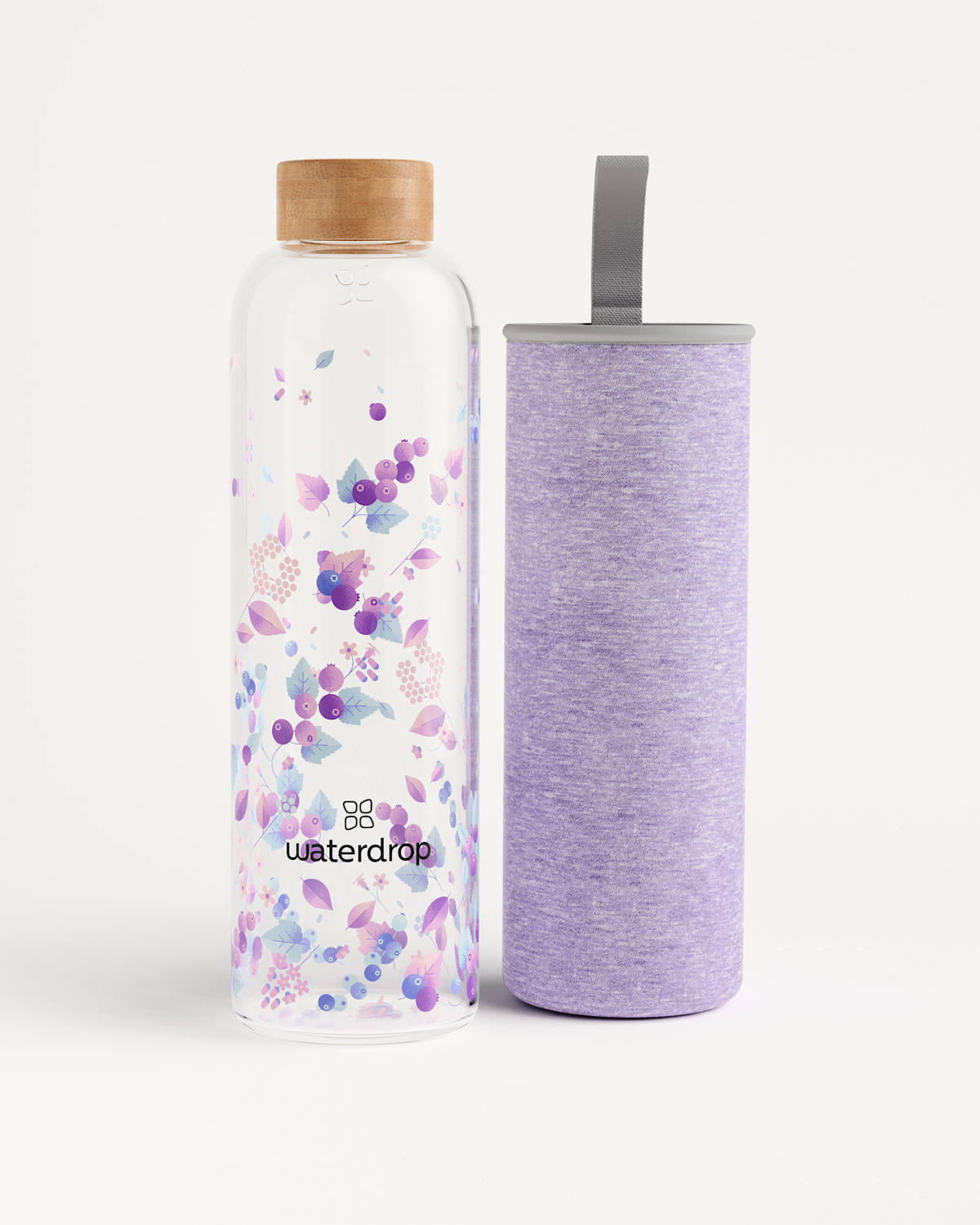 Edition Glass bottle next to its detachable cylinder, made of durable borosilicate glass, perfect for eco-friendly hydration on the go. Available in multiple sizes.