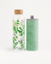 Ricola Edition Glass bottle with floral motif and sleeve.