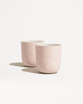 Marble Cups with embossed flower logo, double-walled porcelain design.