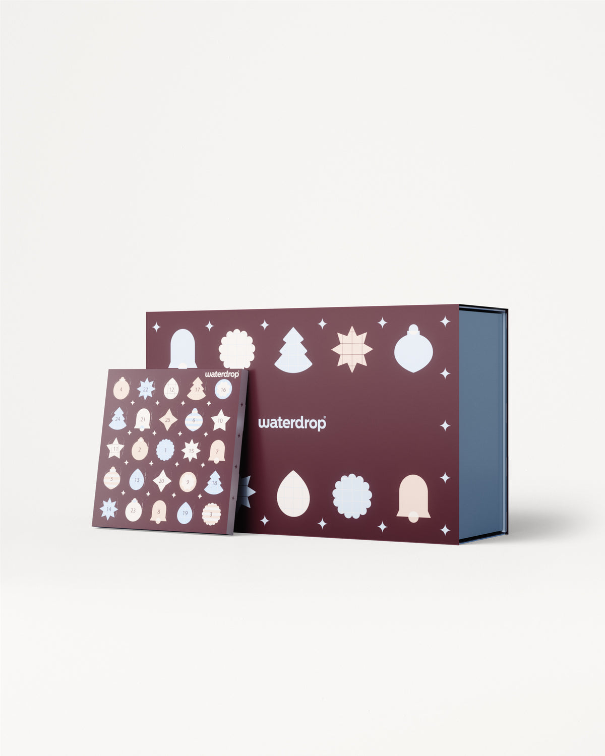 Advent calendar with purple panels featuring white holiday ornaments, shown with a blue interior box.
