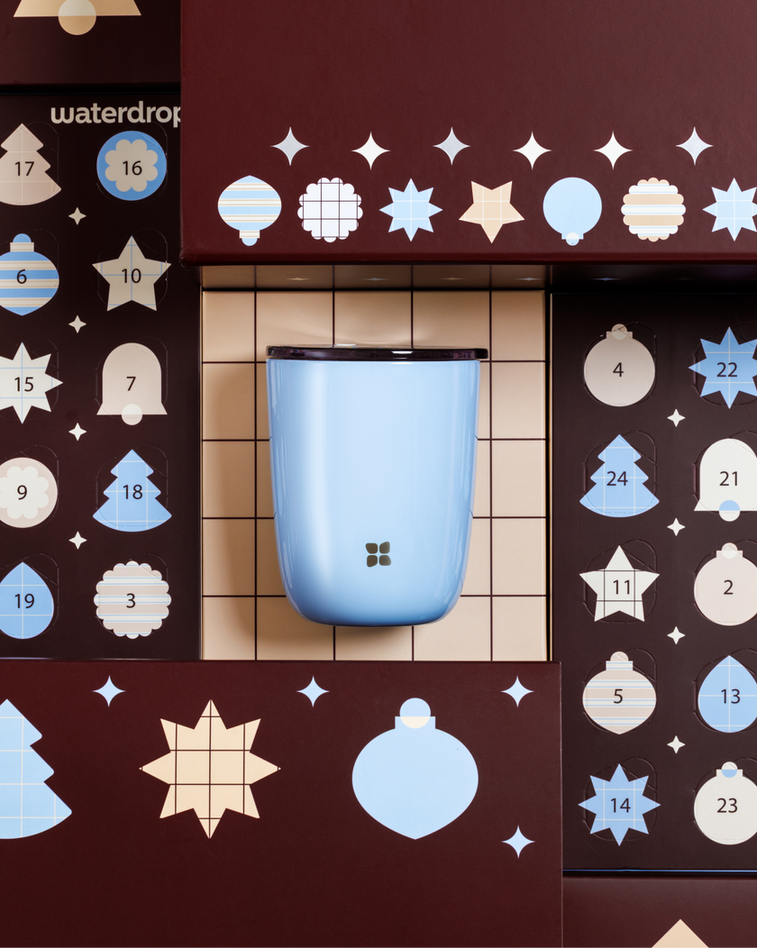 Light blue rounded container mounted on a wooden display panel with decorative circular and star-shaped cutouts.