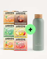 Assorted Waterdrop drink boxes arranged beside a pale green reusable bottle with a cork cap and a green plus sign.