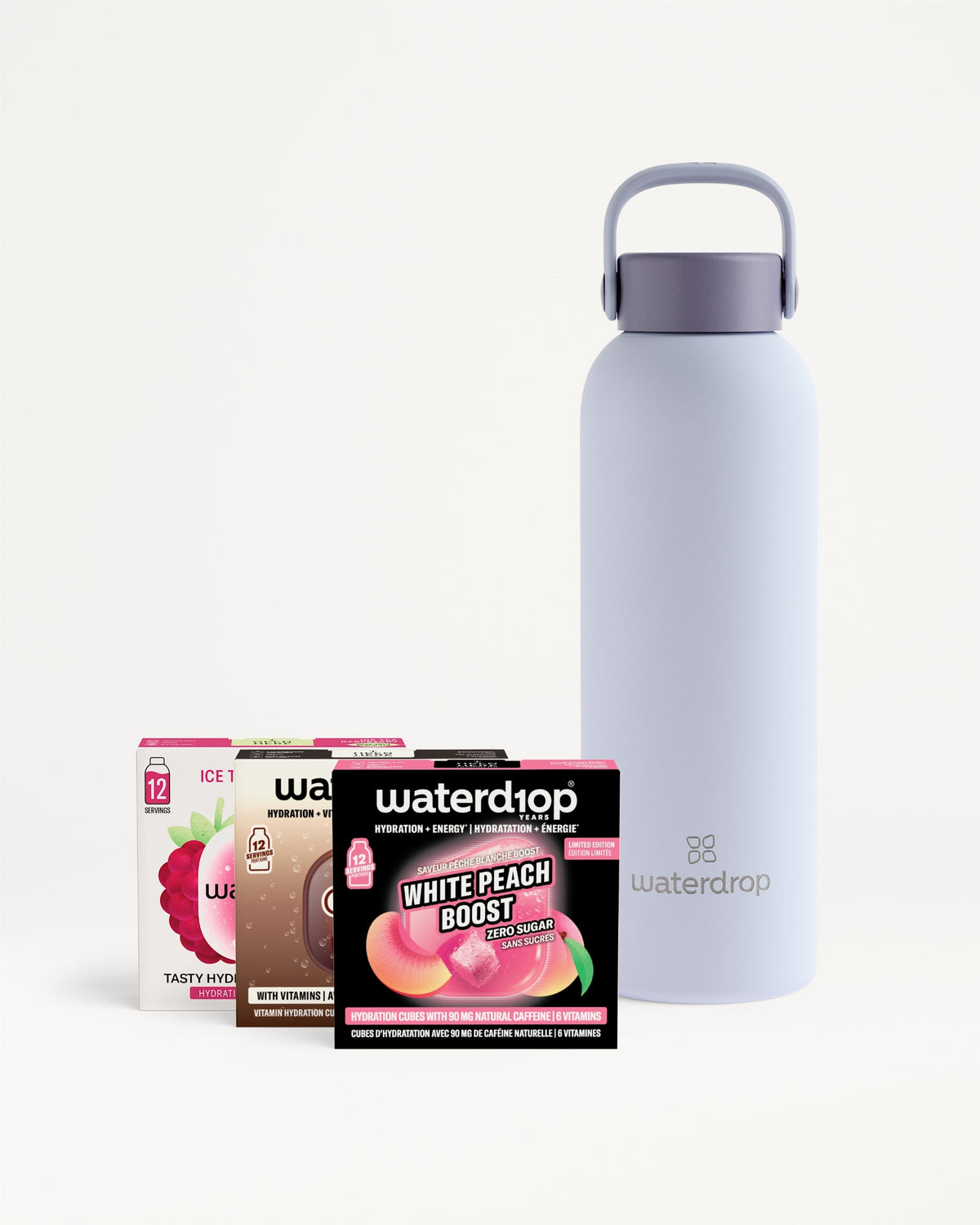Lavender reusable water bottle with a carrying handle beside four flavor sachet boxes.