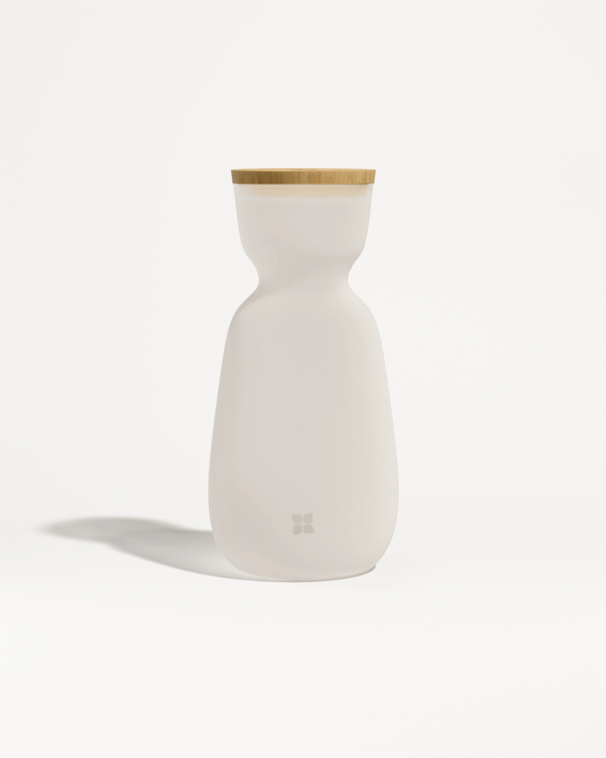 White ceramic bottle with a light wood lid and a smooth, curved body.