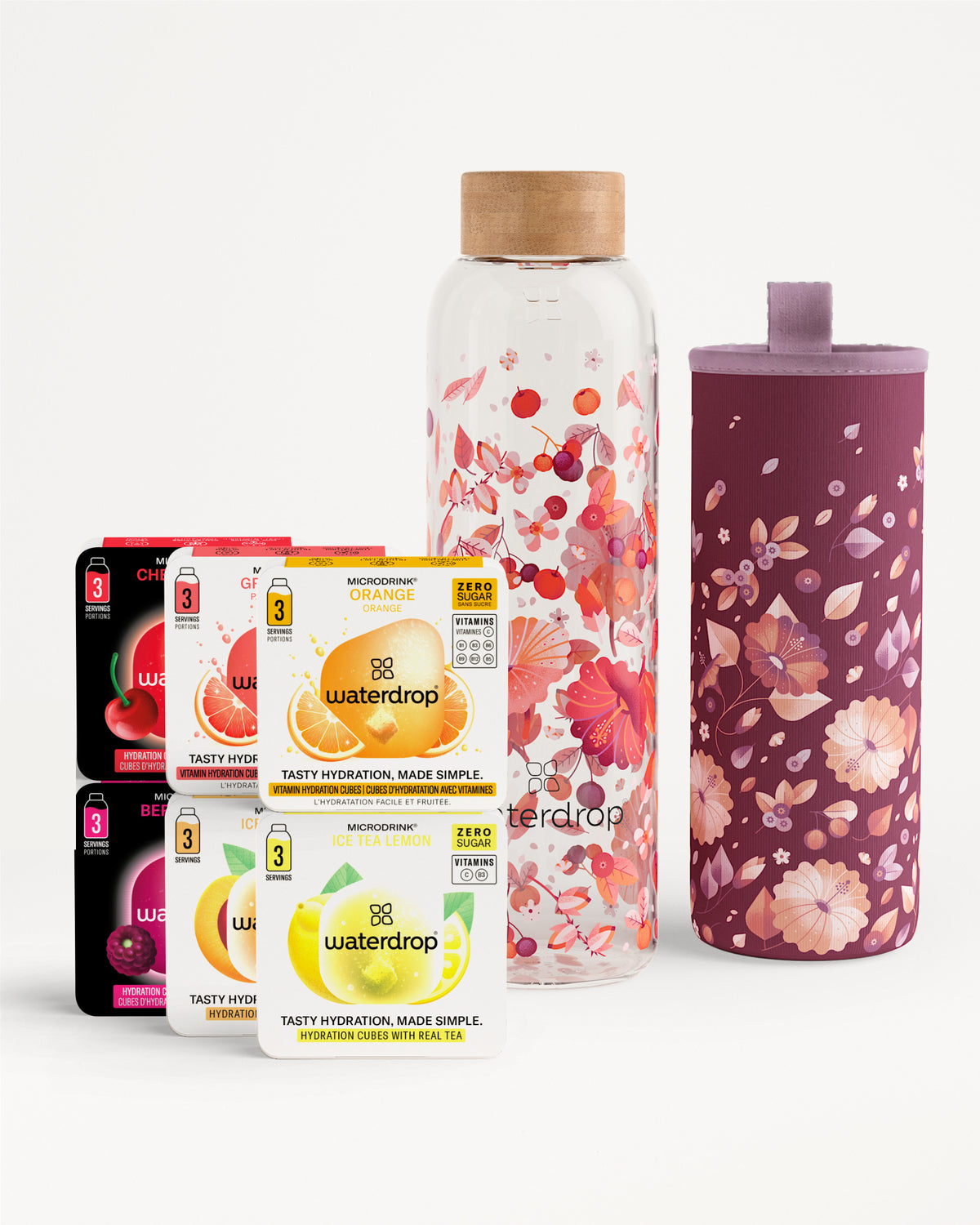 Assorted Waterdrop flavor tablet boxes with a floral glass water bottle and matching floral sleeve.