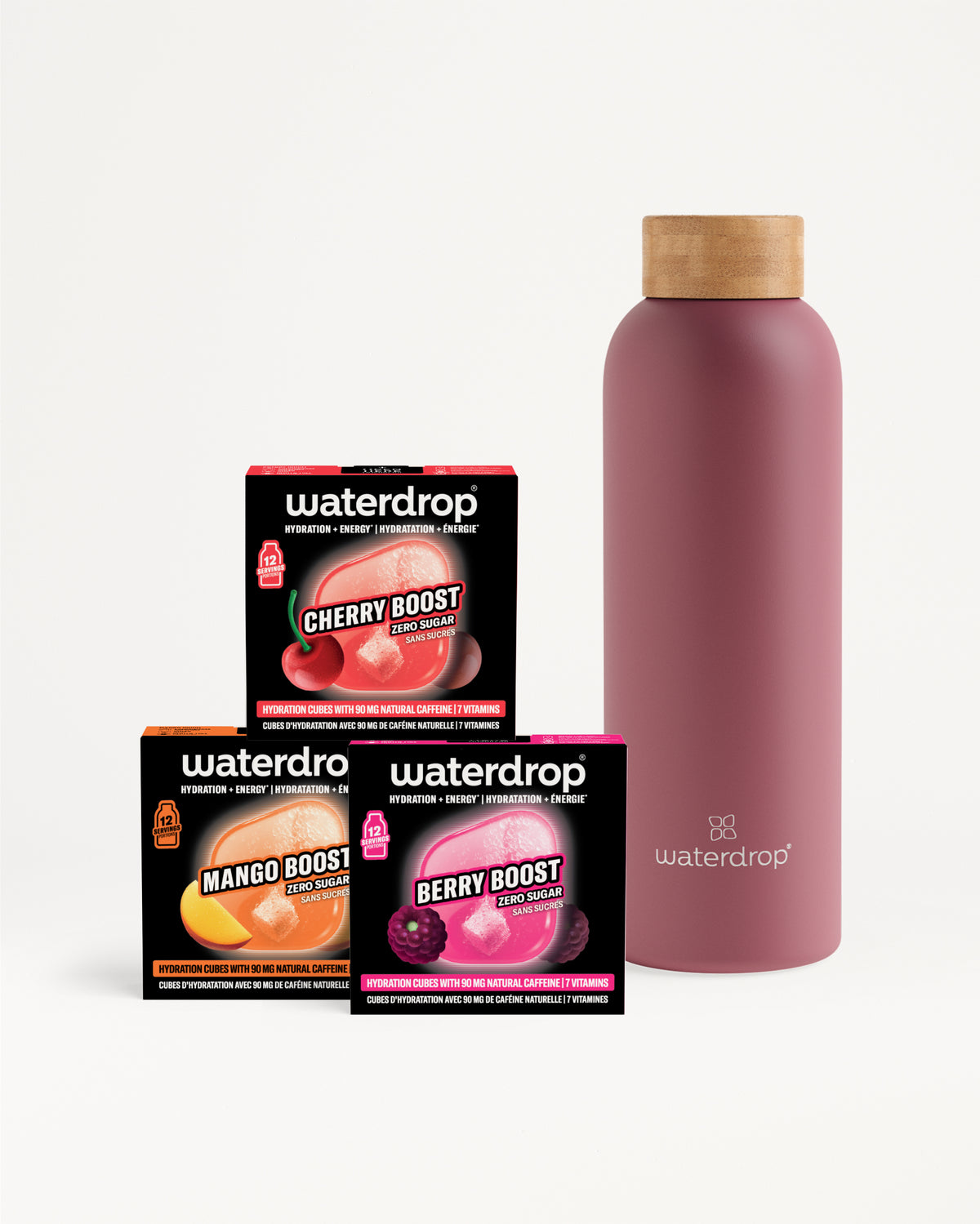 Three compact Waterdrop flavor booster boxes beside a pink reusable bottle with a wooden cap.