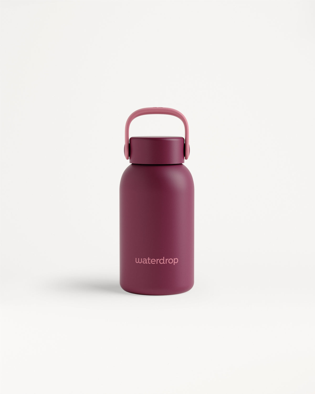 Magenta reusable water bottle with a curved handle on a white background.