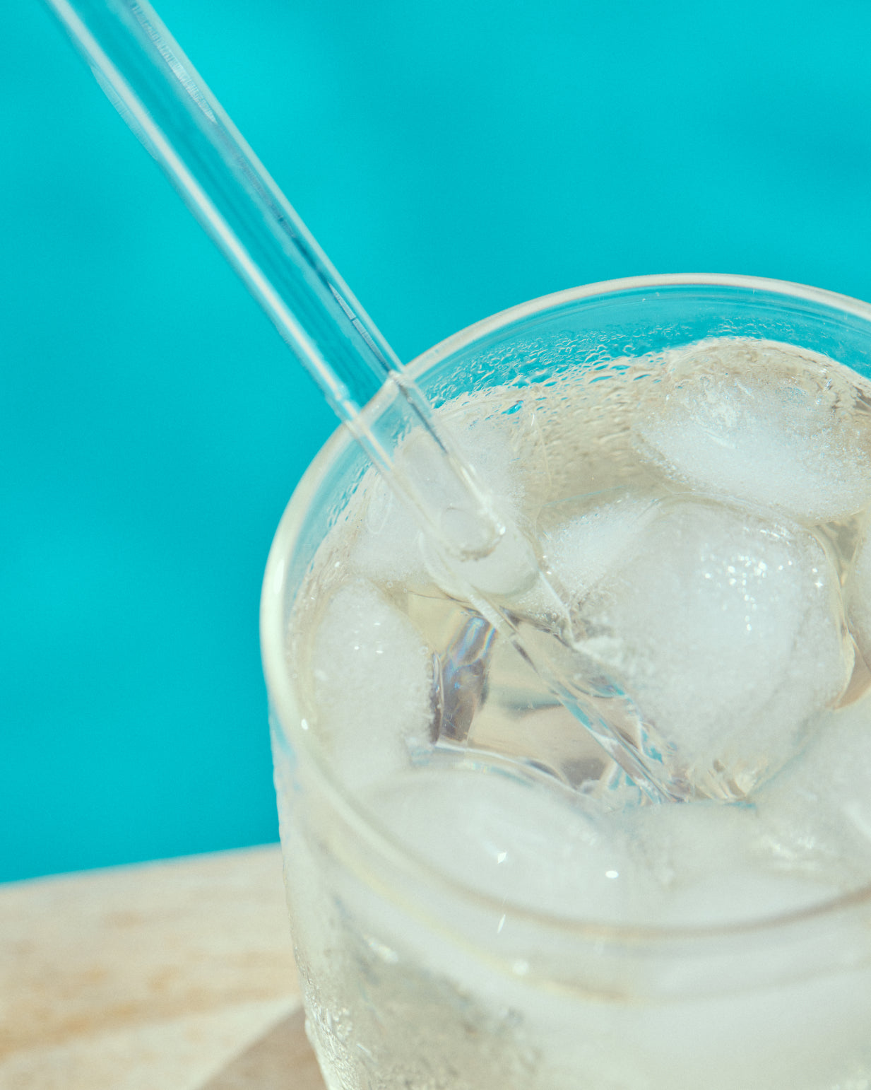 Glass with ice, straw, and liquid promoting KOKO PIÑA, a limited-edition tropical coconut and pineapple hydration drink from waterdrop®.