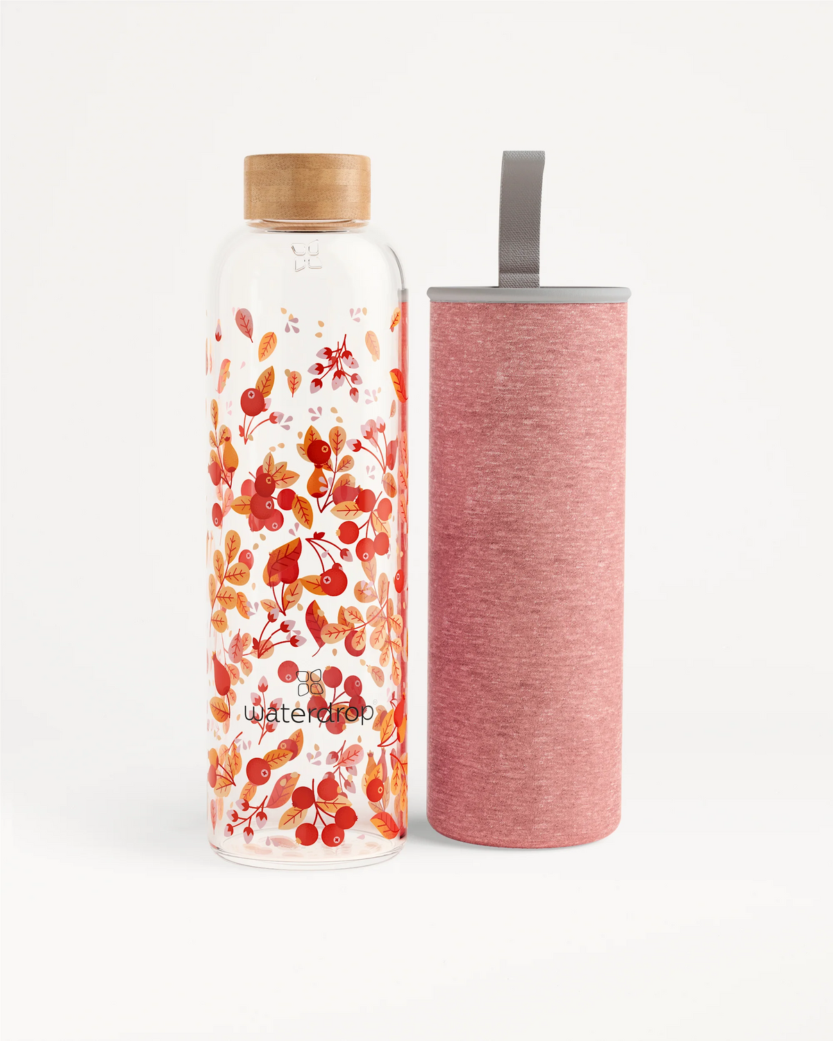 Edition Glass bottle next to a pink container, ideal for eco-friendly hydration on the go. Available in 400ml, 600ml, and 1L sizes.