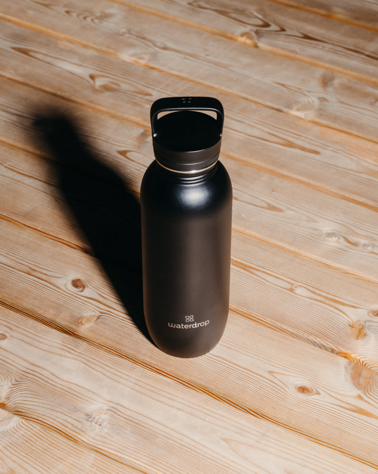 All-Purpose Thermo Straw Lid Gift Set bottle on wood surface.