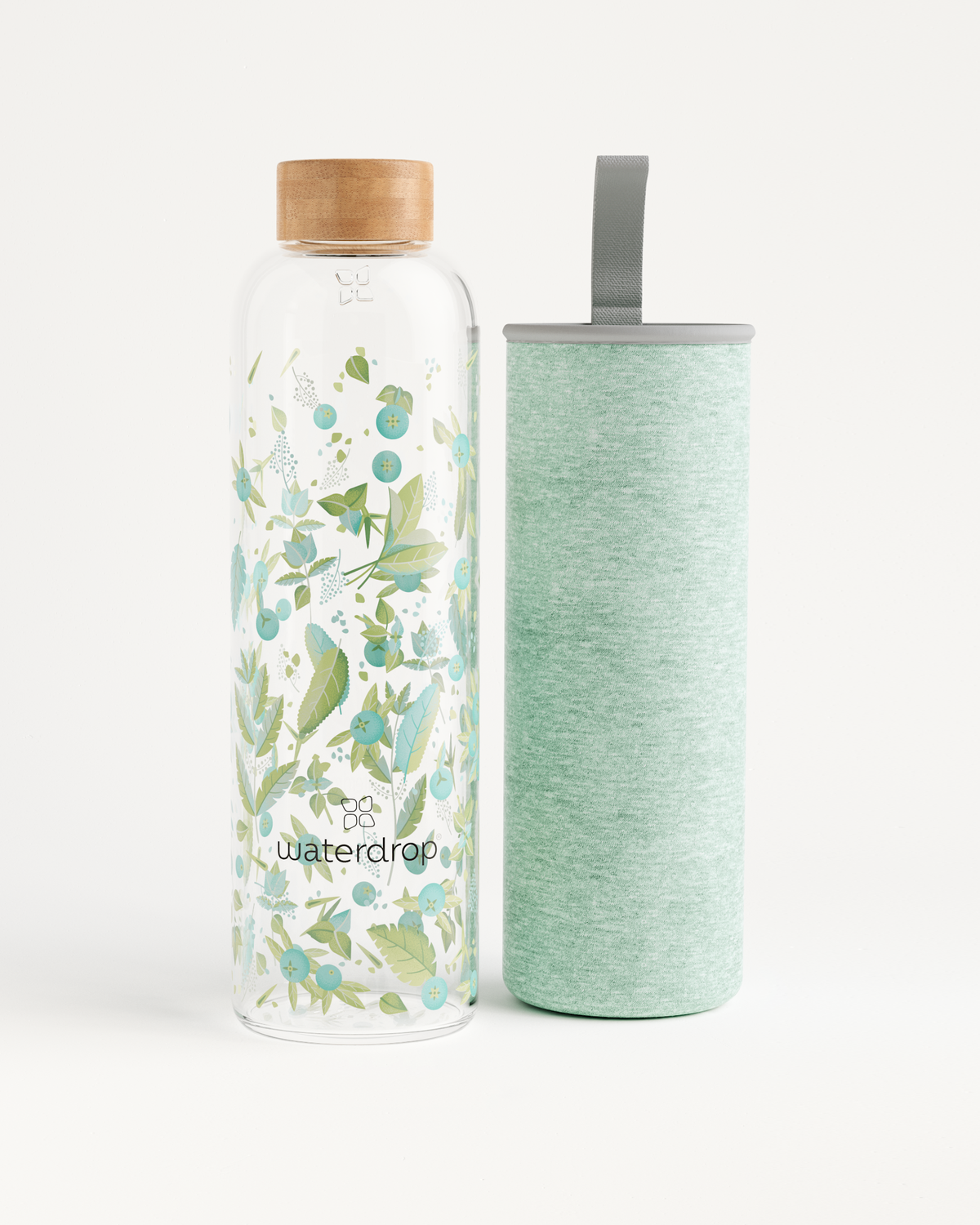 Edition Glass water bottle made of robust borosilicate glass, available in 400ml, 600ml, and 1L, positioned next to another bottle.