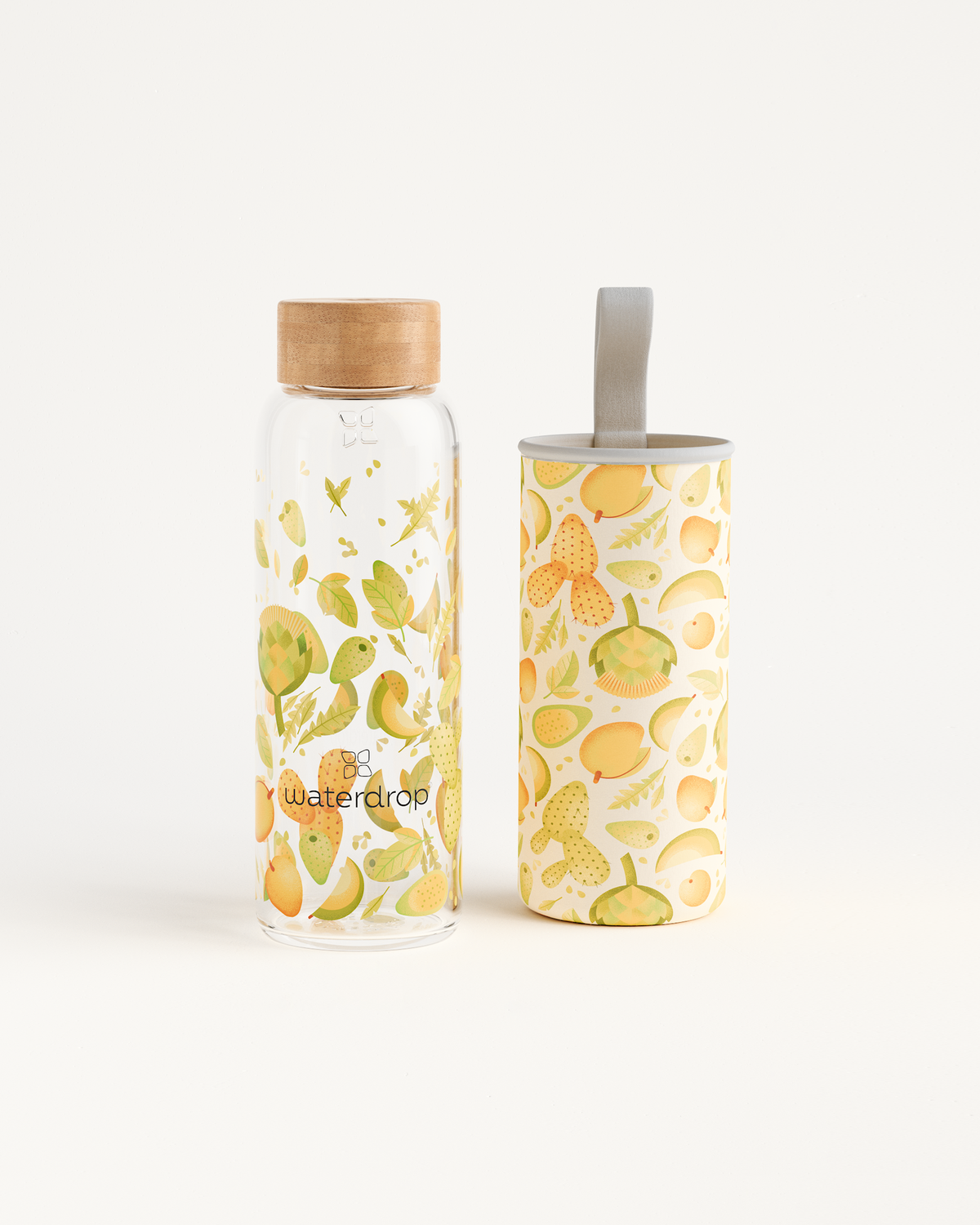 Edition Glass bottle with leaf and flower design next to white container, promoting eco-friendly hydration solutions from waterdrop®. Available in 400ml, 600ml, and 1L.