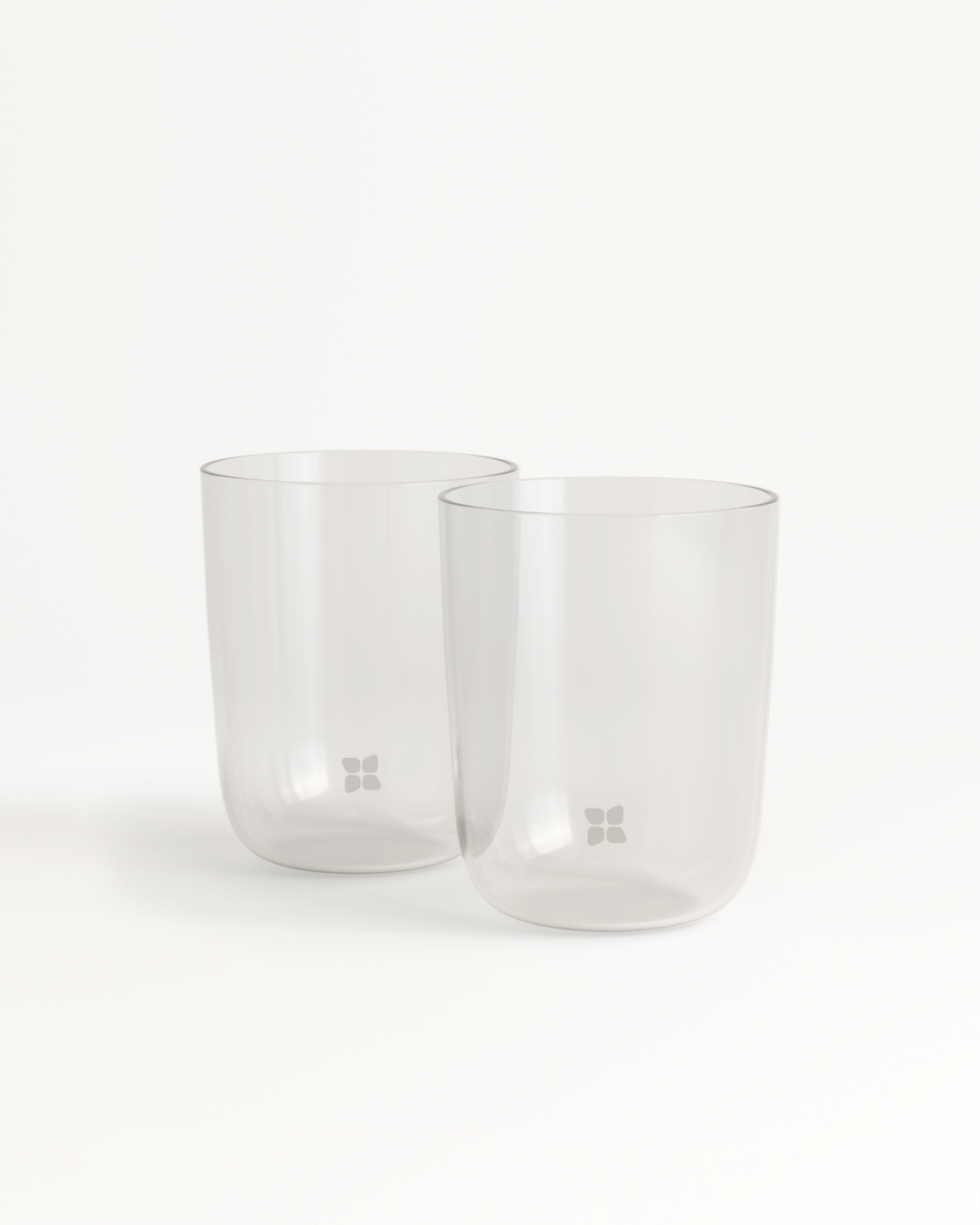 Two clear borosilicate glasses on a white background, showcasing a minimalist design and functionality for enjoying waterdrop® flavors.