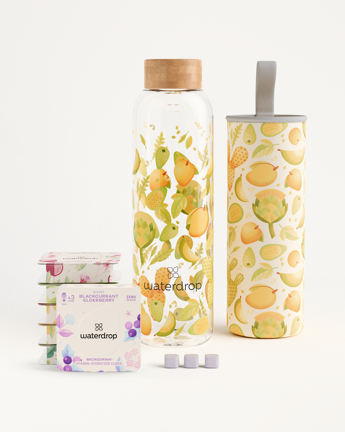 Starter Set Microdrink Glass includes six Microdrink 3-Packs and a high-quality borosilicate glass water bottle, displayed with fruit-patterned containers and a box.