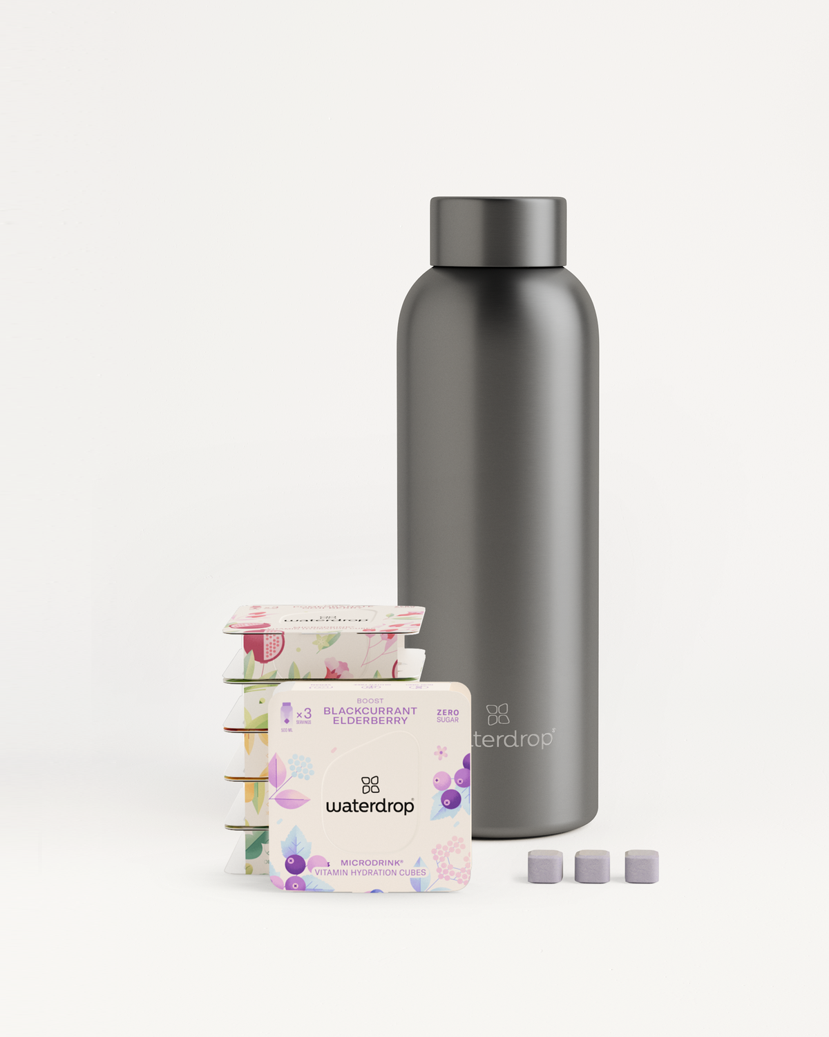 Starter Set Microdrink Metal Thermo Steel: A black stainless steel bottle with six microdrink flavor packs in practical 3-Pack boxes.