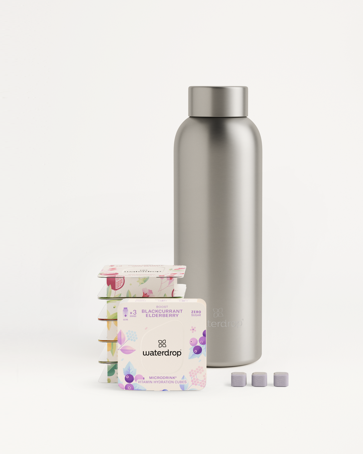 Starter Set Microdrink Metal Thermo Steel: Silver stainless steel bottle with three packs of flavored tea cubes.