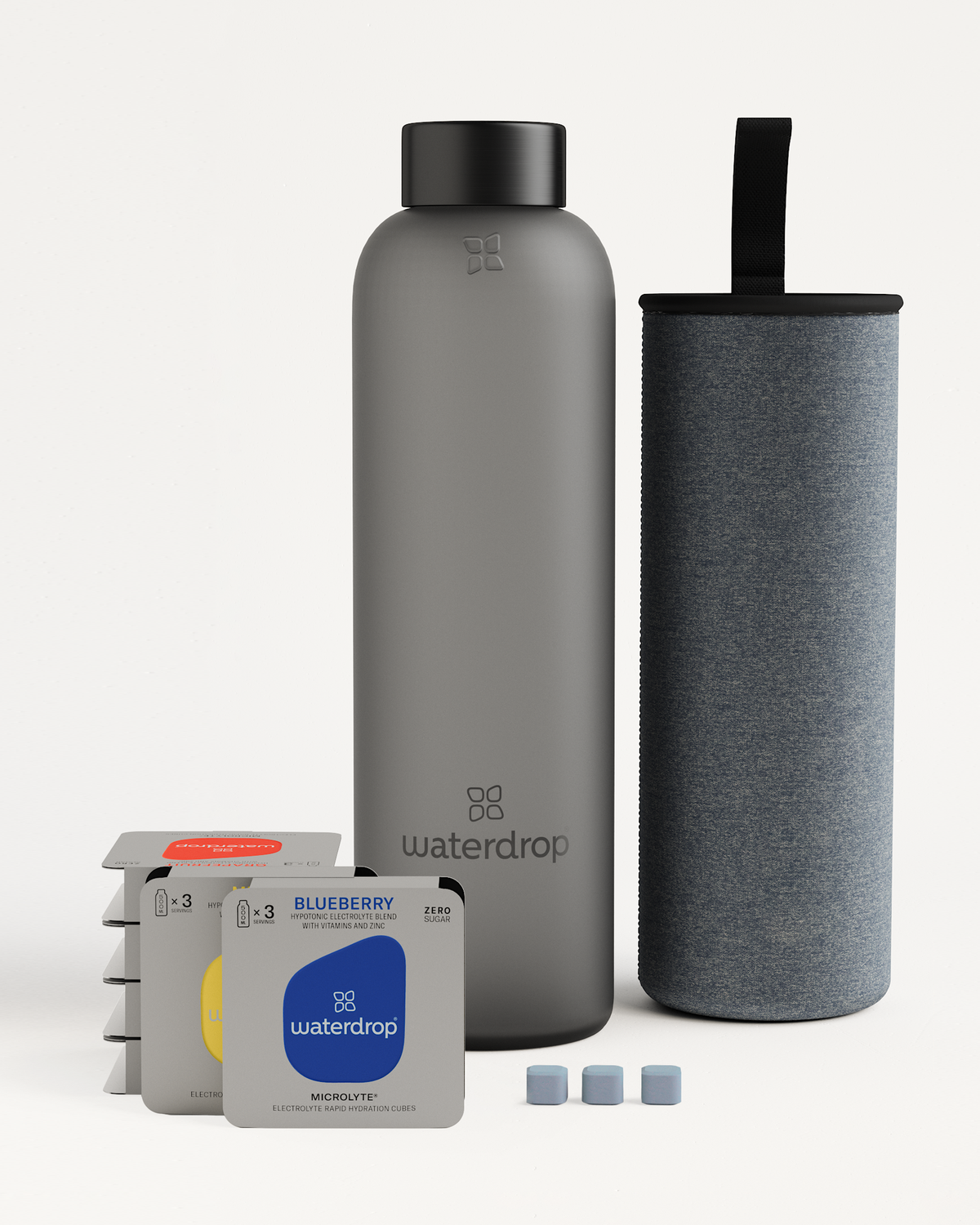 Starter Set Microlyte Glass with a grey water bottle, water filter, and Microlyte cubes. Ideal for exercise, featuring electrolytes, vitamins, and zinc.