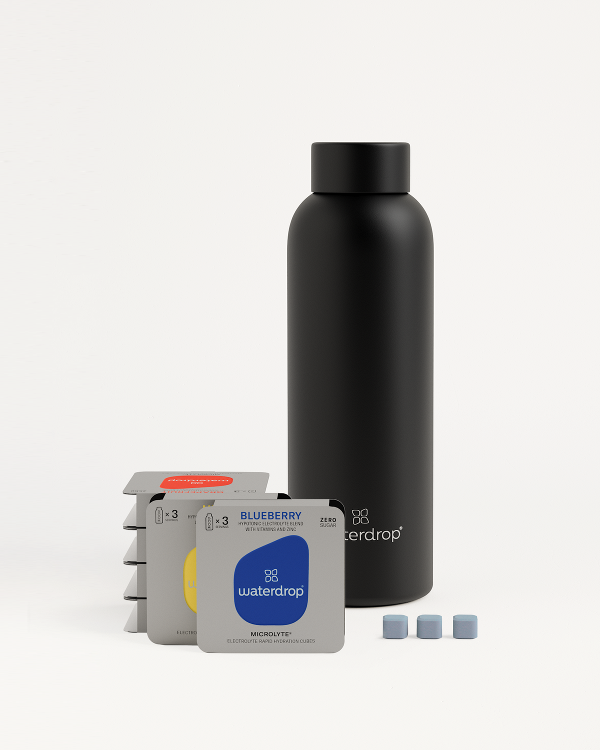 Starter Set Microlyte Thermo Steel: black bottle and small packages of Blueberry, Grapefruit, and Melon Microlyte flavors for hydration before, during, and after workouts.