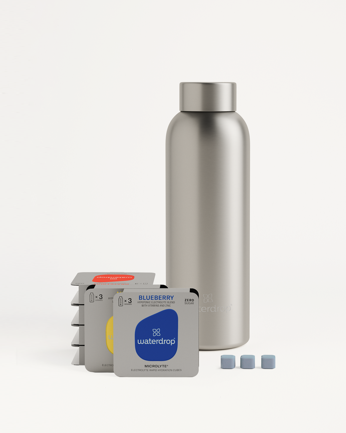 Starter Set Microlyte Thermo Steel: Silver bottle with small boxes of Microlyte flavors (Blueberry, Grapefruit, Melon) arranged beside it.