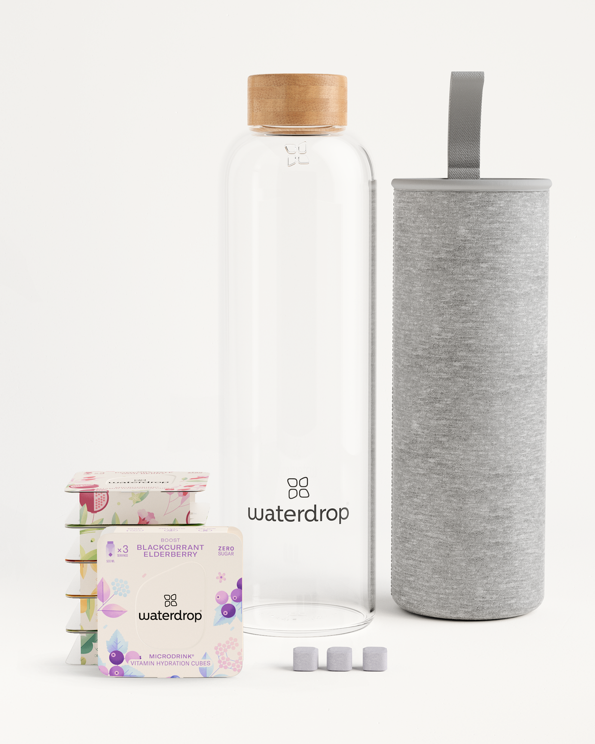 Starter Set Microdrink Glass with a Borosilicate Glass Bottle and a box of elderberry flavoring, including three-pack Microdrinks in floral-themed boxes.