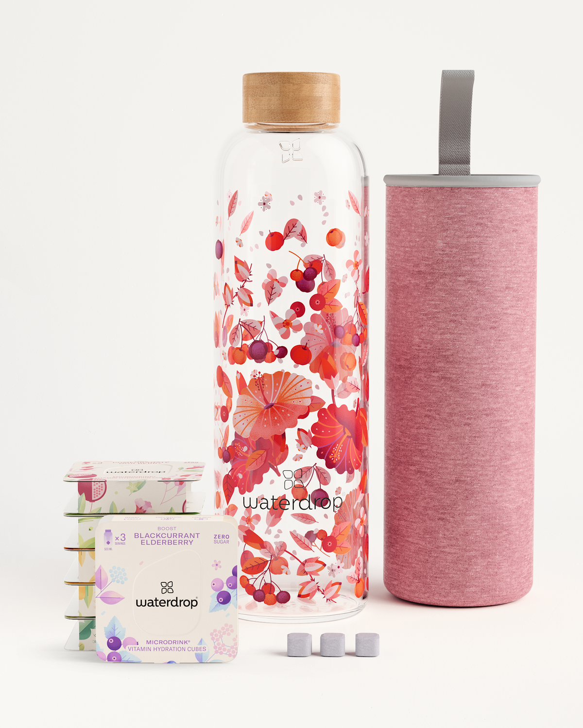 Starter Set Microdrink Glass: bottle with floral design, pink container, and elderberry flavoring box. Includes six Microdrink 3-Packs and a Borosilicate Glass Bottle.