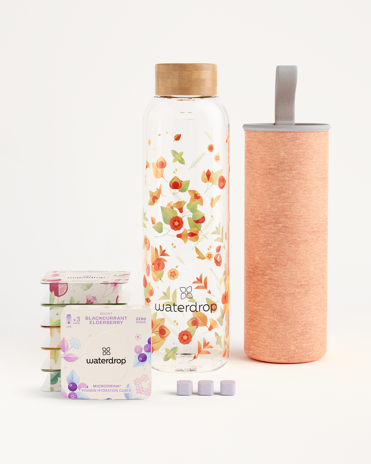 Starter Set Microdrink Glass showcasing a borosilicate glass bottle and a box of elderberry flavoring cubes, perfect for trying multiple flavors.