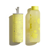 FLAIR Glass bottle with a yellow lid and floral label, designed by Viktor & Rolf, made from borosilicate glass for stylish hydration on the go.